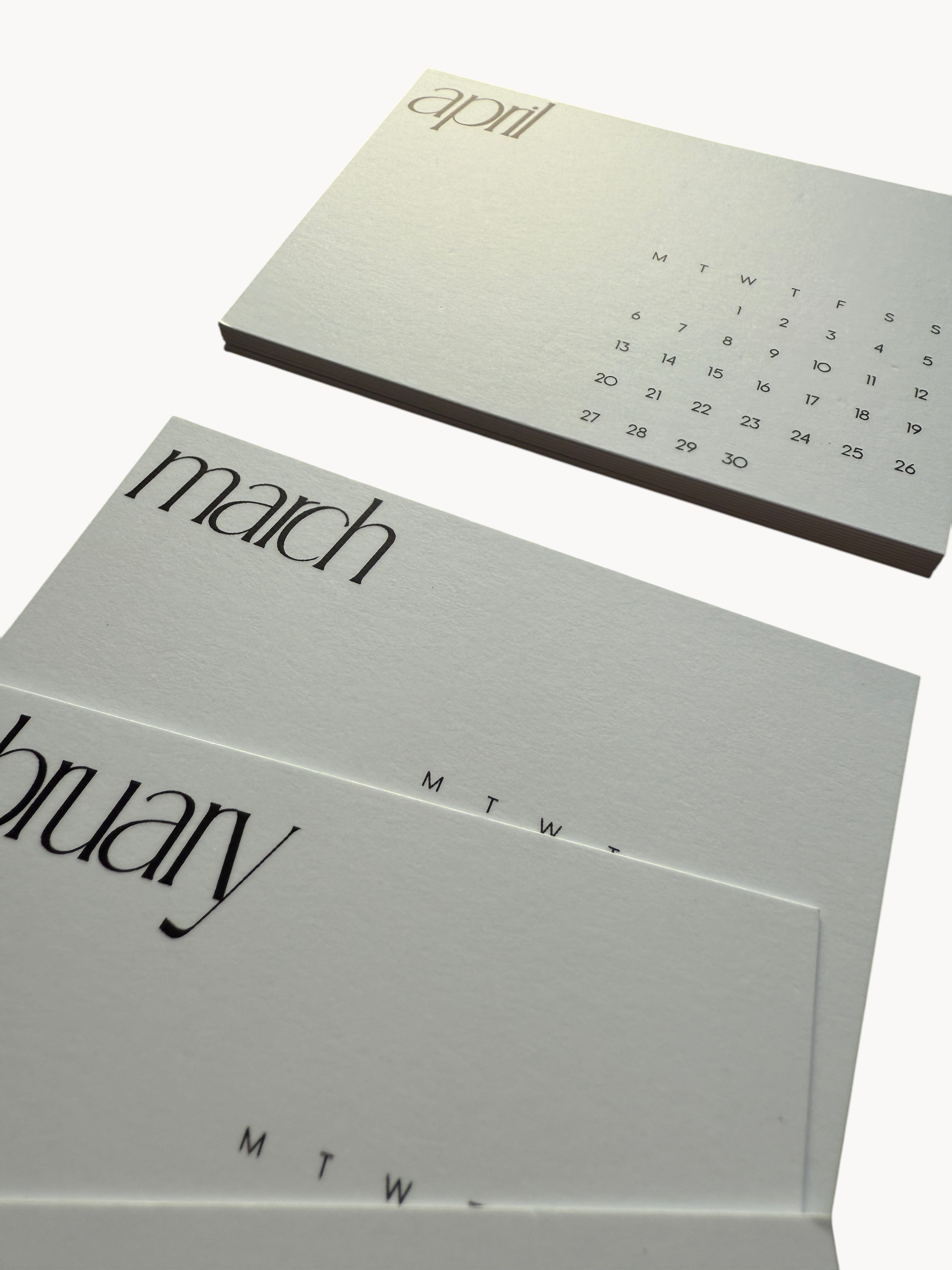 BUDGETNEEDS ™ 2026 calendar card set featuring minimalist white offset paper with elegant black typography