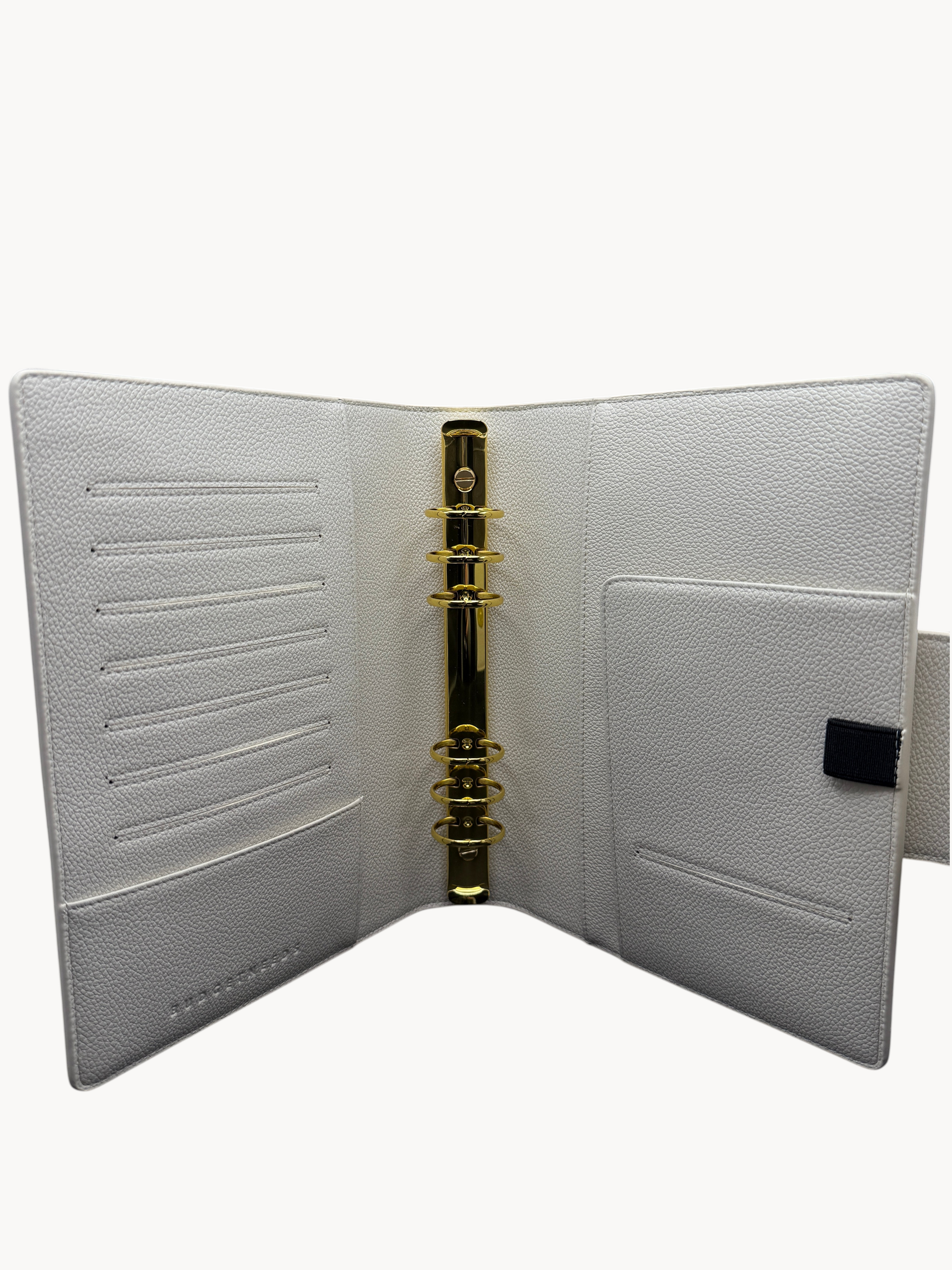BUDGETNEEDS ™ A5 MiniFlap ring binder in cream with gold hardware, featuring card slots and a pen holder.