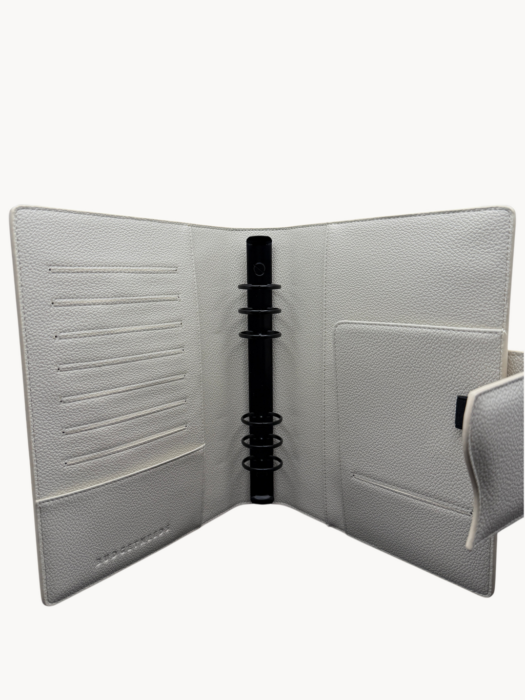 BUDGETNEEDS ™ A5 MiniFlap ring binder in cream with matte black hardware, featuring card slots and a pen holder.
