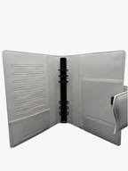 BUDGETNEEDS ™ A5 MiniFlap ring binder in cream with matte black hardware, featuring card slots and a pen holder.