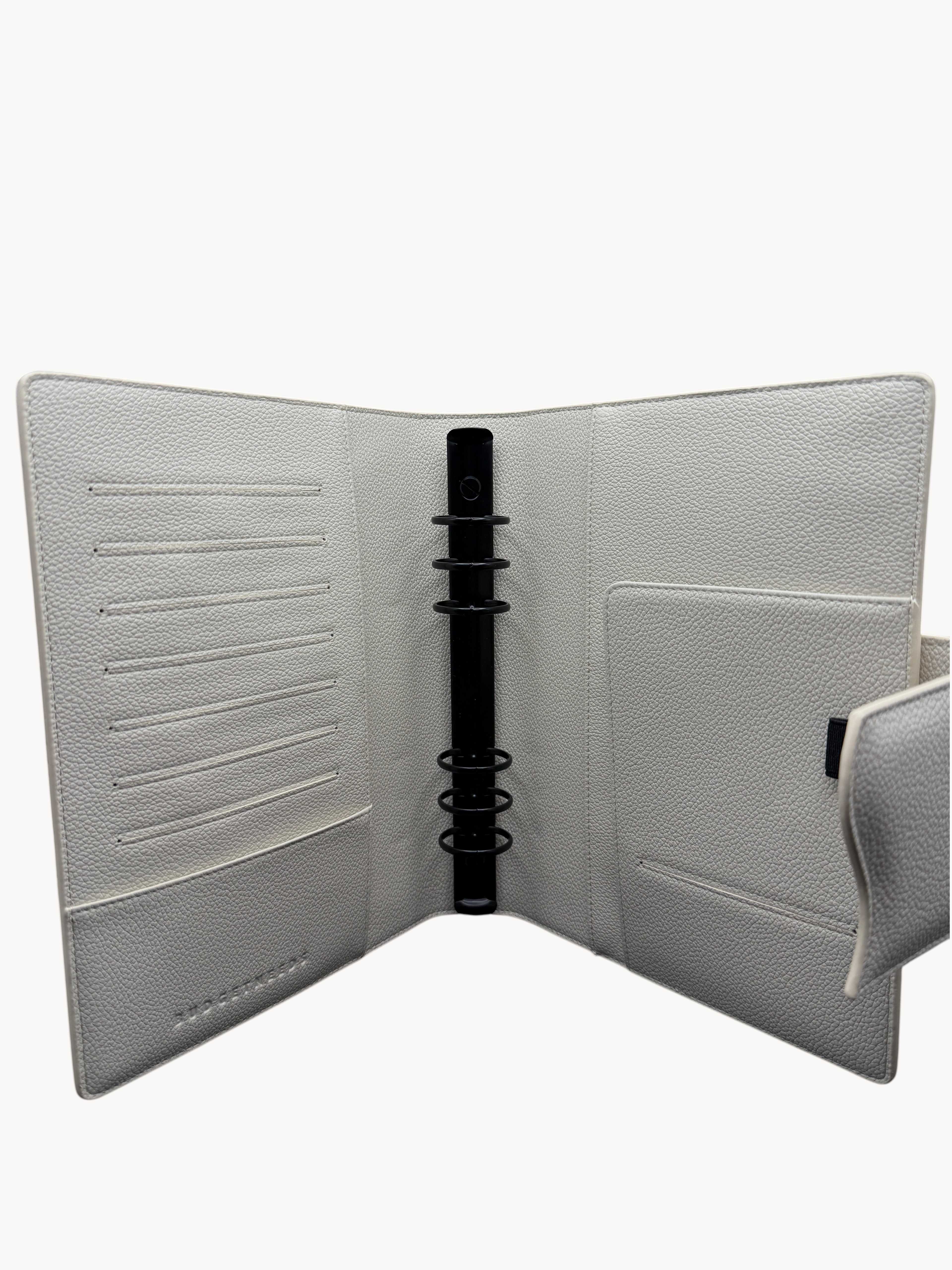 BUDGETNEEDS ™ A5 MiniFlap ring binder in cream with matte black hardware, featuring card slots and a pen holder.