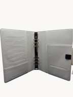 BUDGETNEEDS ™ A5 MiniFlap ring binder in cream with matte black hardware, pen holder, and interior card slots.