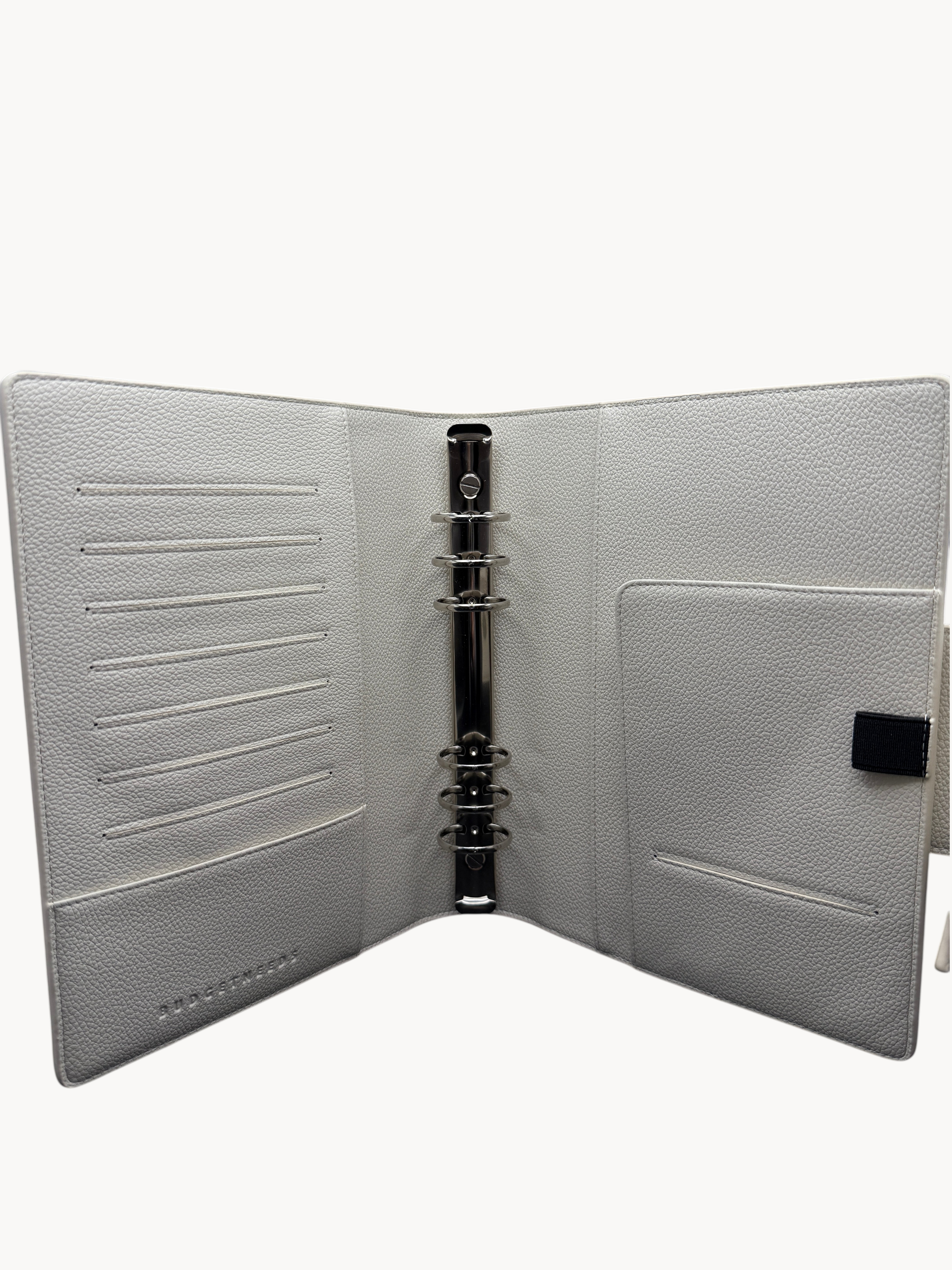 BUDGETNEEDS ™ A5 MiniFlap ring binder in cream with matte black hardware, pen holder, and interior card slots.