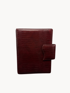 BUDGETNEEDS ™ A5 MiniFlap ring binder in ruby red with a crocodile texture and magnetic button closure.