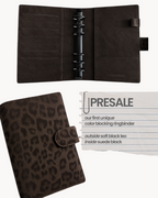 BUDGETNEEDS ™ A6 vegan leather ring binder in soft black leopard print with dark interior and black hardware.