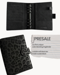 BUDGETNEEDS ™ A6 ring binder in black vegan leather with a subtle leopard print pattern and black hardware.