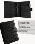 BUDGETNEEDS ™ A6 ring binder in black vegan leather with a subtle leopard print pattern and black hardware.