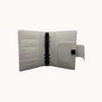 BUDGETNEEDS ™ A6 MiniFlap ring binder in cream with matte black hardware, pen holder, and magnetic closure.