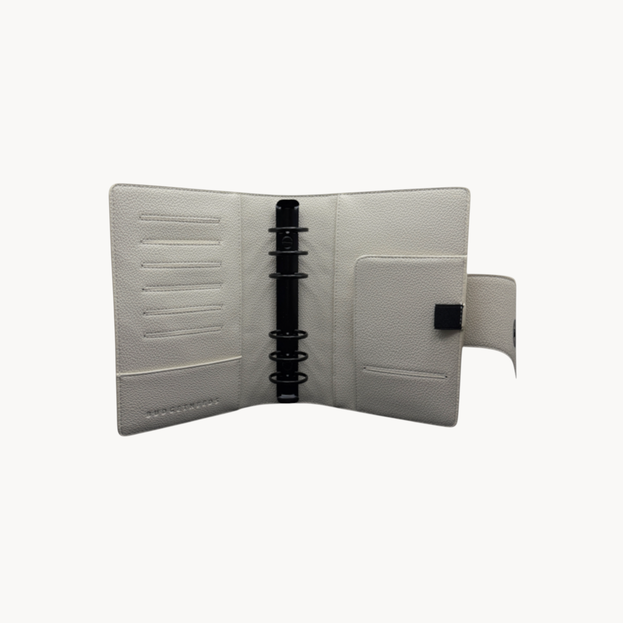 BUDGETNEEDS ™ A6 MiniFlap ring binder in cream with matte black hardware, pen holder, and magnetic closure.