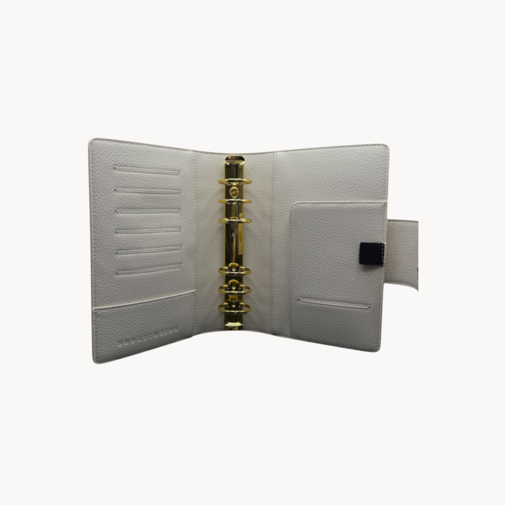 BUDGETNEEDS ™ A6 MiniFlap ring binder in cream with gold hardware, pen holder, and magnetic closure.