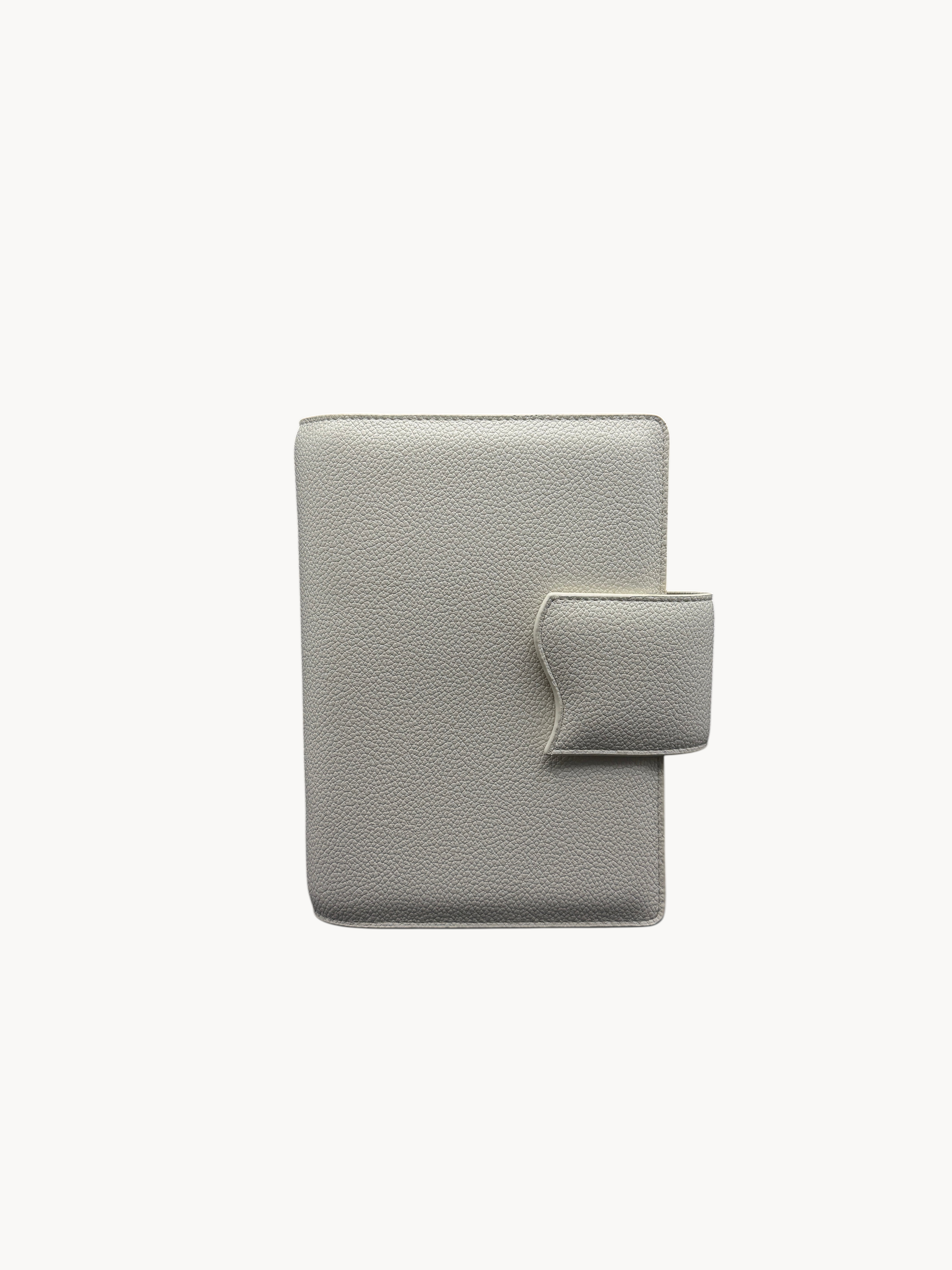 BUDGETNEEDS ™ A6 MiniFlap ring binder in cream with a magnetic button closure and minimalist textured finish.