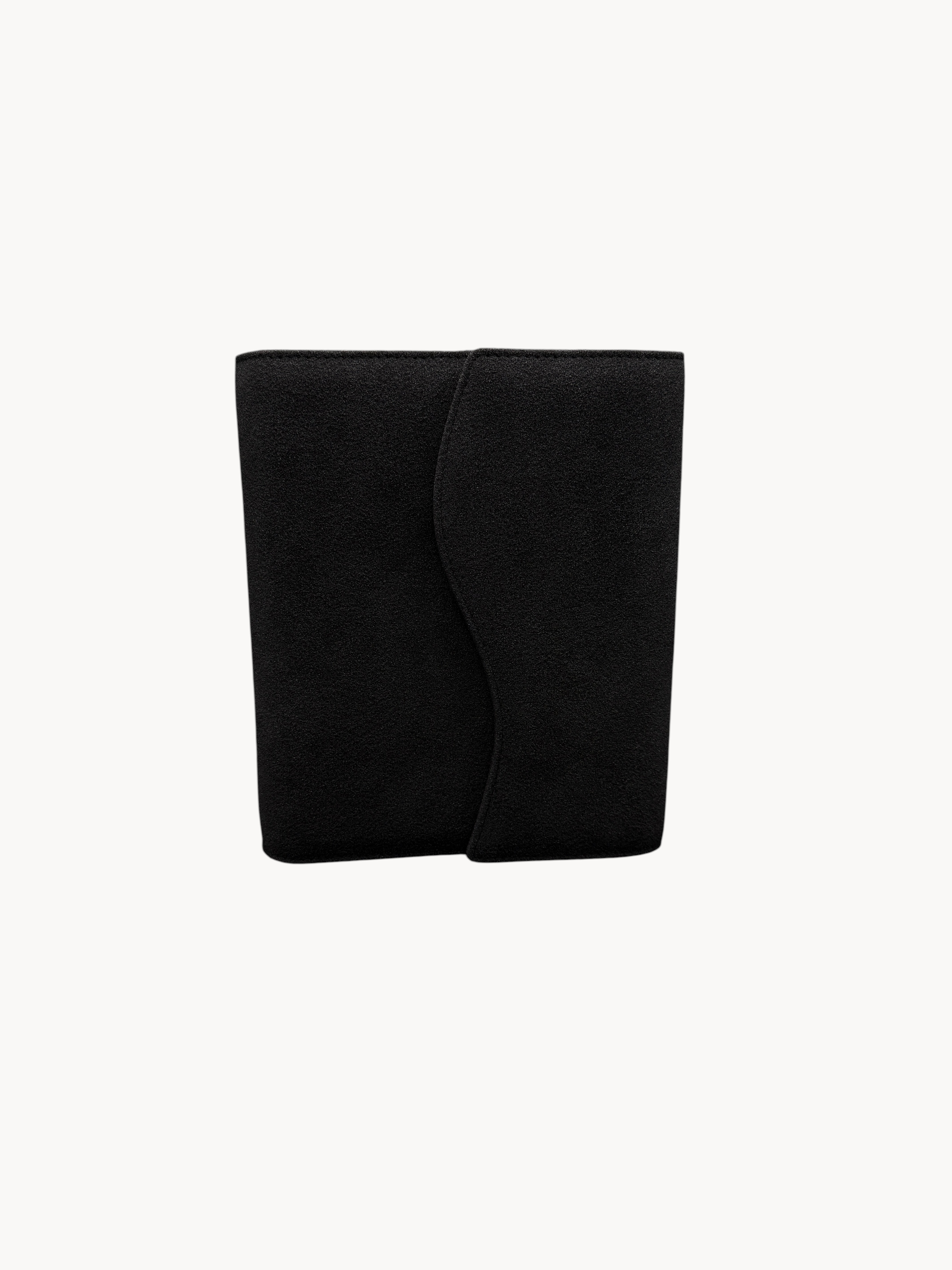 BUDGETNEEDS ™ black suede ring binder with a curved flap closure, shown from a front view against a plain background.