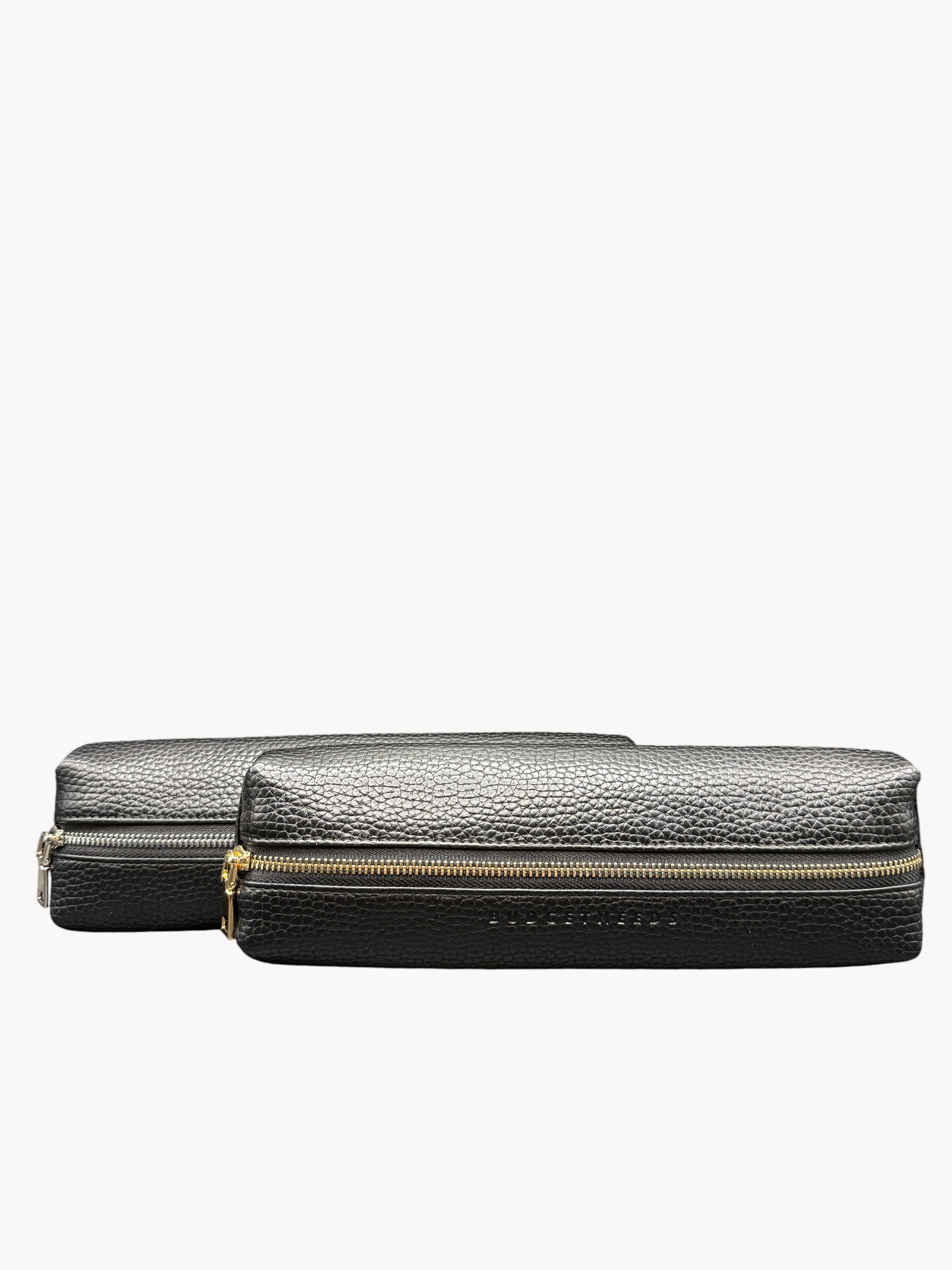 BUDGETNEEDS ™ black vegan leather pencil case with gold zipper hardware on a dark background