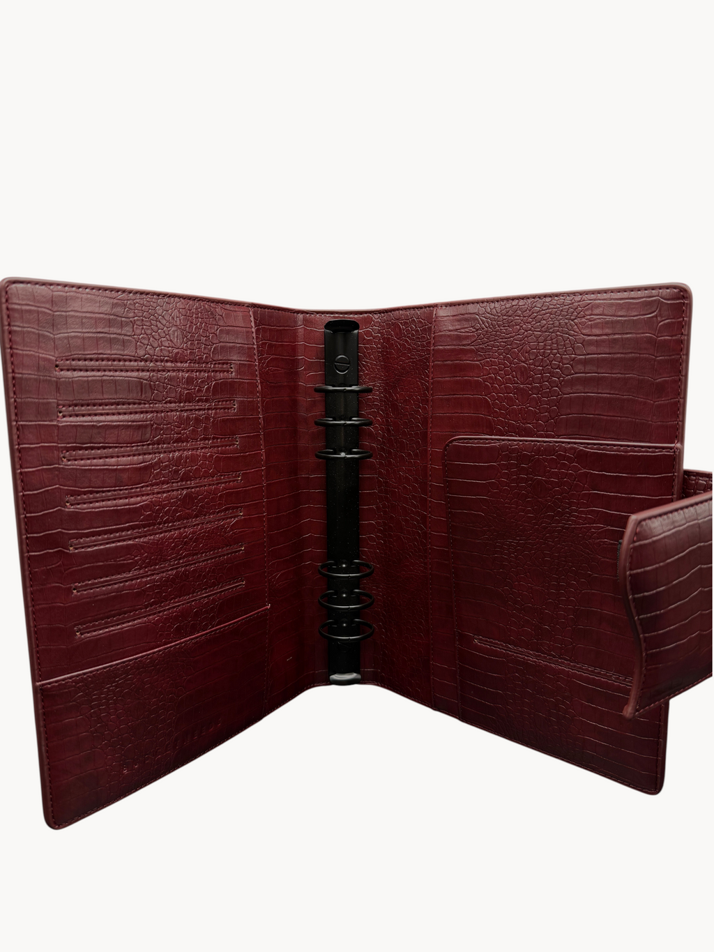 BUDGETNEEDS ™ A5 MiniFlap ring binder in ruby red with a crocodile texture, matte black hardware, and pen holder.