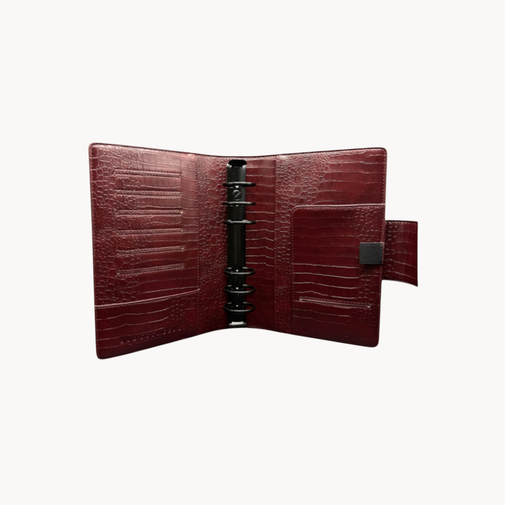 BUDGETNEEDS ™ A6 MiniFlap ring binder in ruby red with a crocodile texture, magnetic closure, and black hardware.