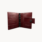 BUDGETNEEDS ™ A6 MiniFlap ring binder in ruby red with a crocodile texture, magnetic closure, and black hardware.