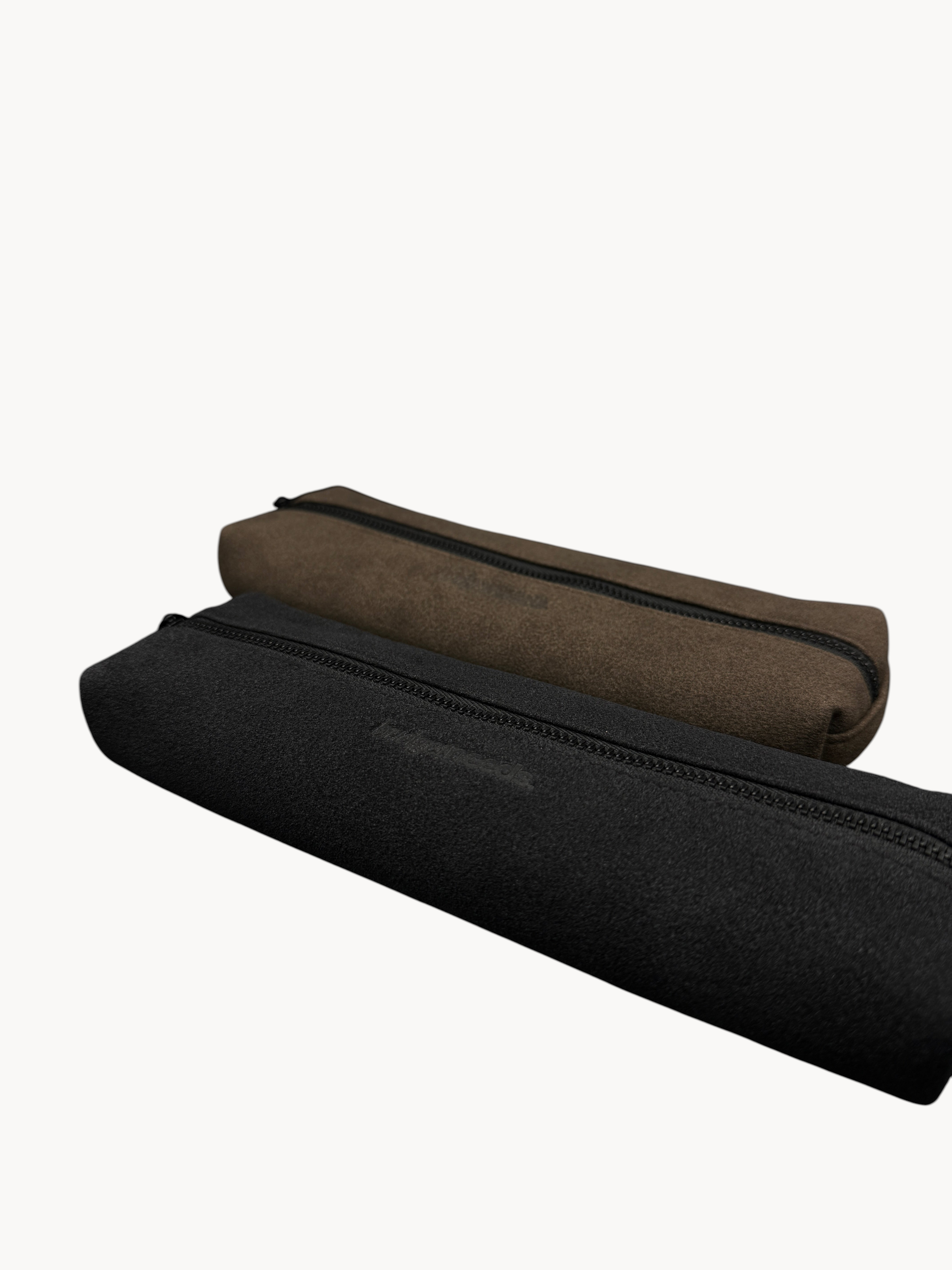 BUDGETNEEDS ™ vegan suede pencil cases in black and taupe with matching zippers on a dark background