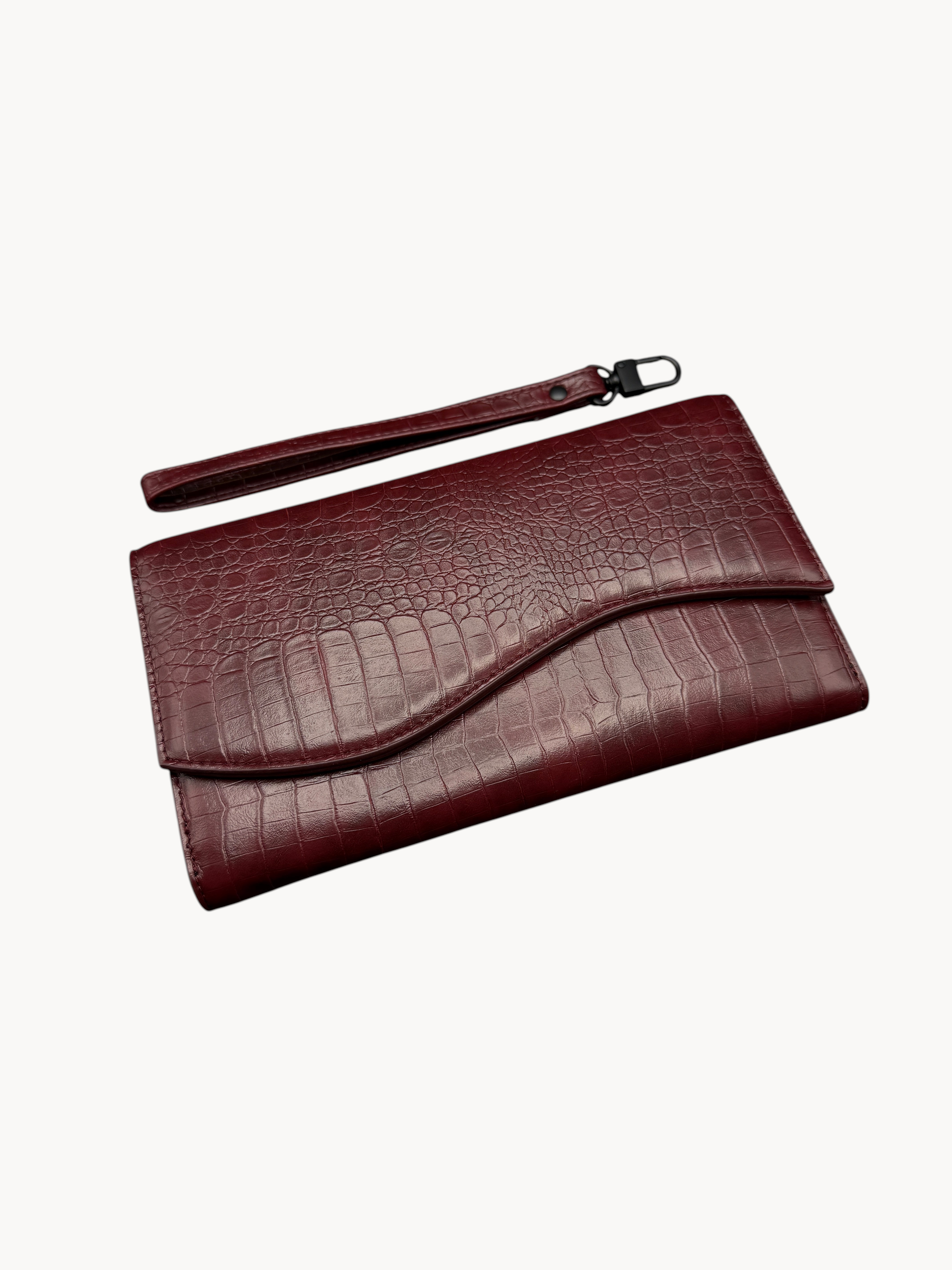 BUDGETNEEDS ™ Wallet Wave in dark red with a crocodile-embossed texture, featuring a wrist strap and flap closure.
